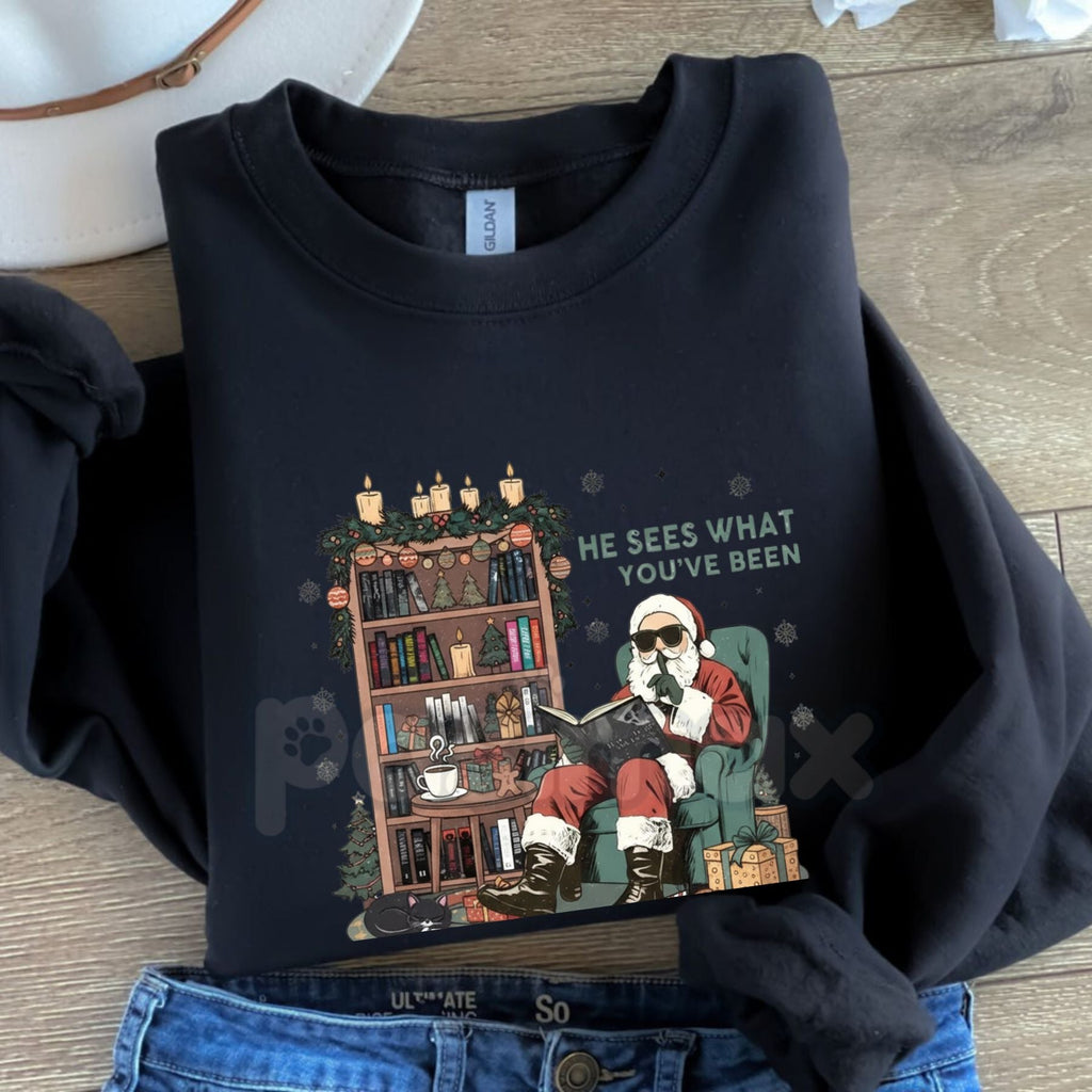 He Sees What You've Been Reading Shirt Sweatshirt | Funny Book Lover Holiday Jumper | Santa Surveillance Reading Gift